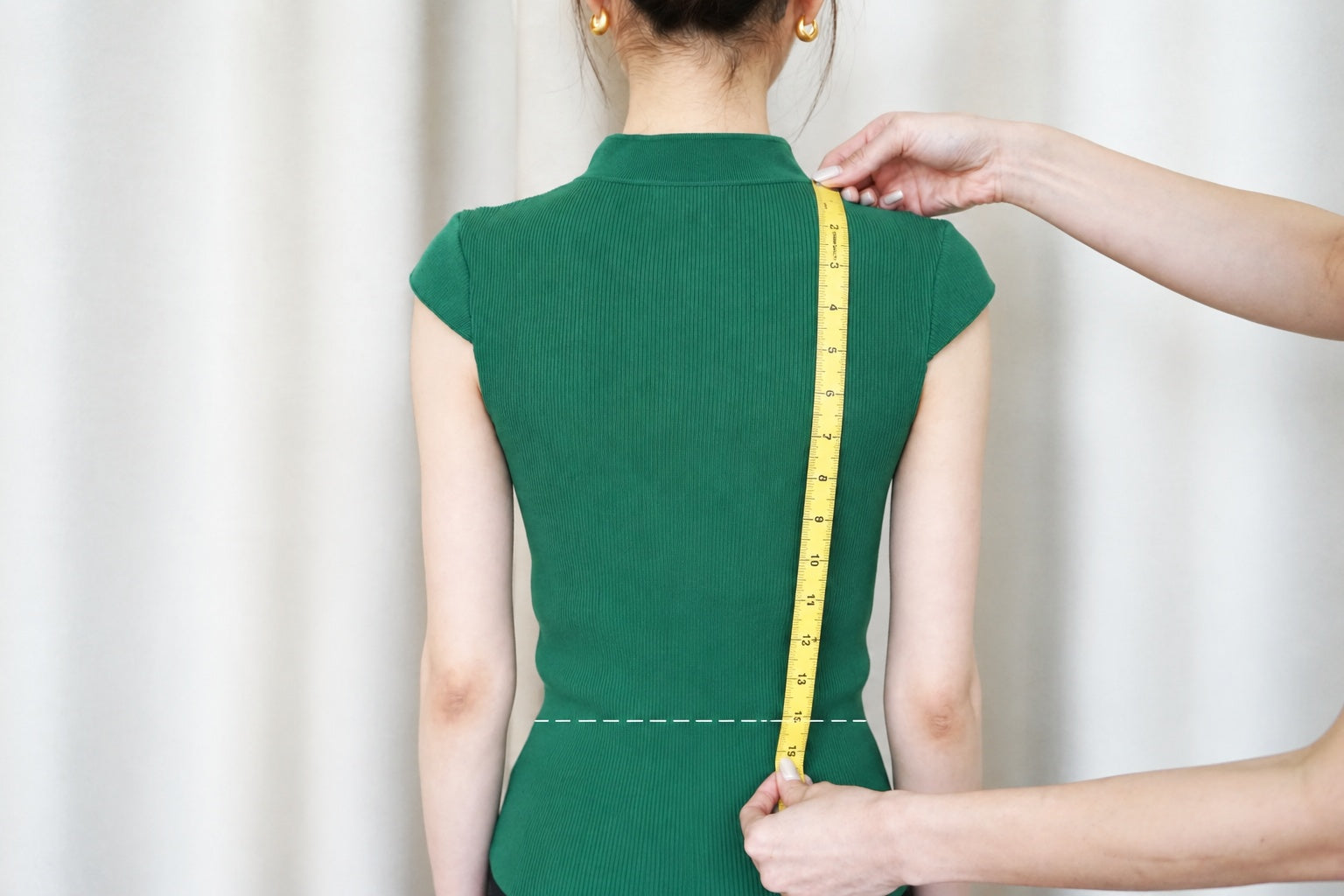 Measuring the back waist length from shoulder to waist