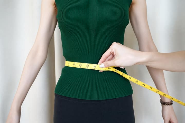 KoKodress model being measured around the natural waist