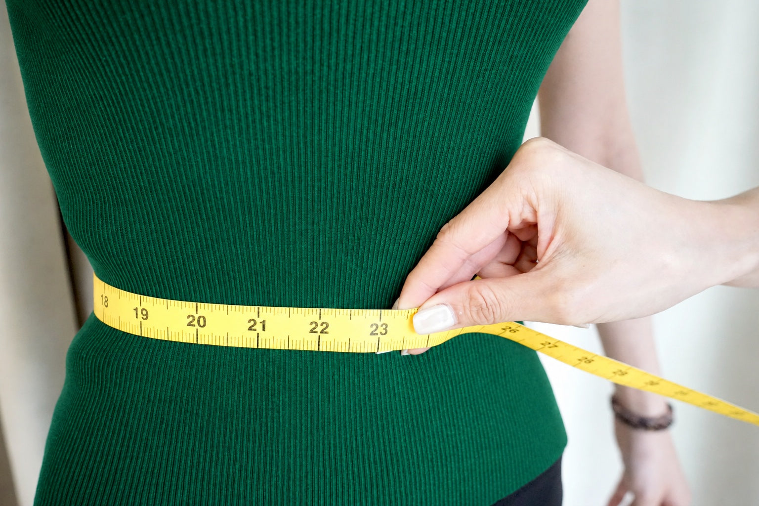 Close view of the tape at the natural waistline